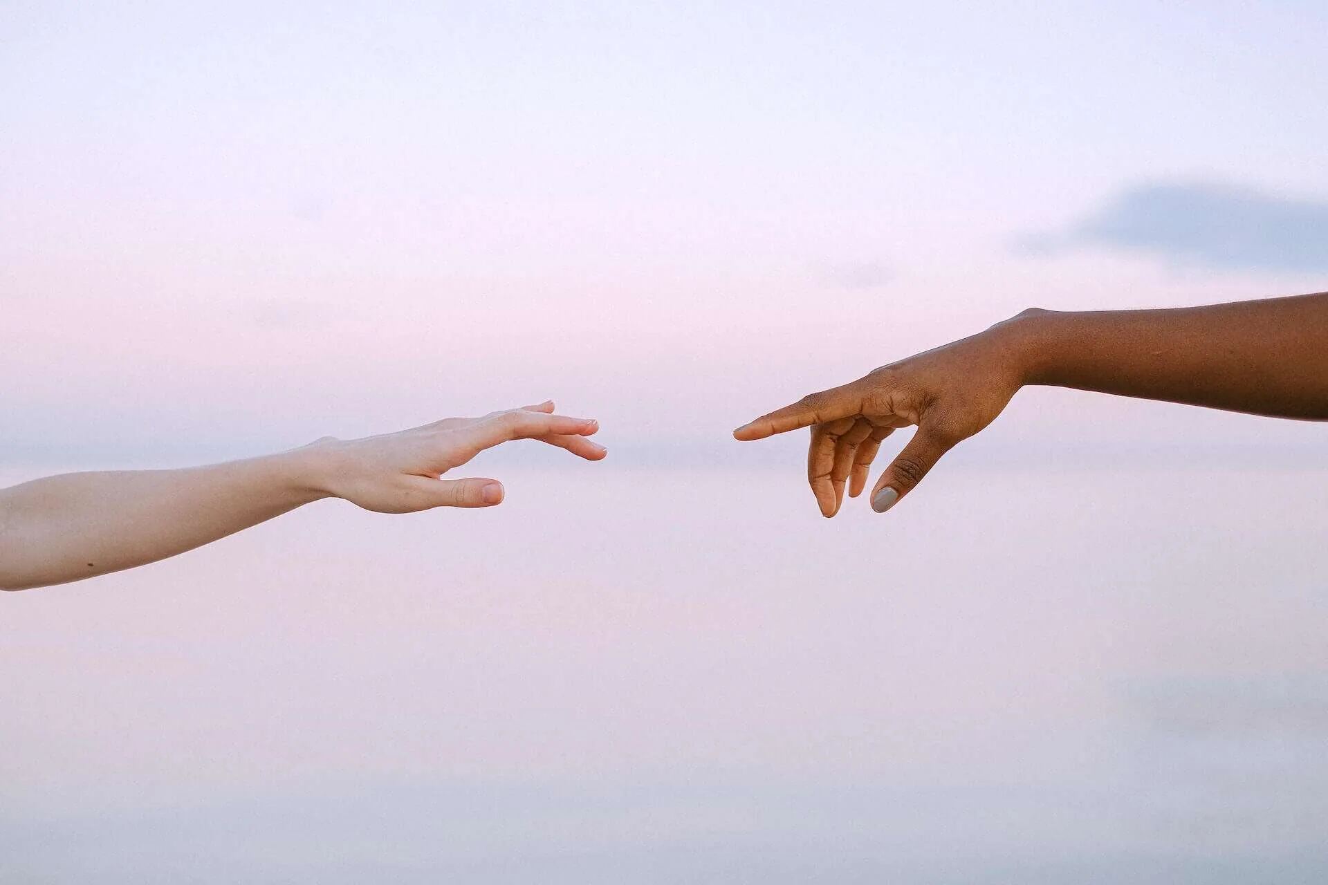 Two hands reaching toward each other